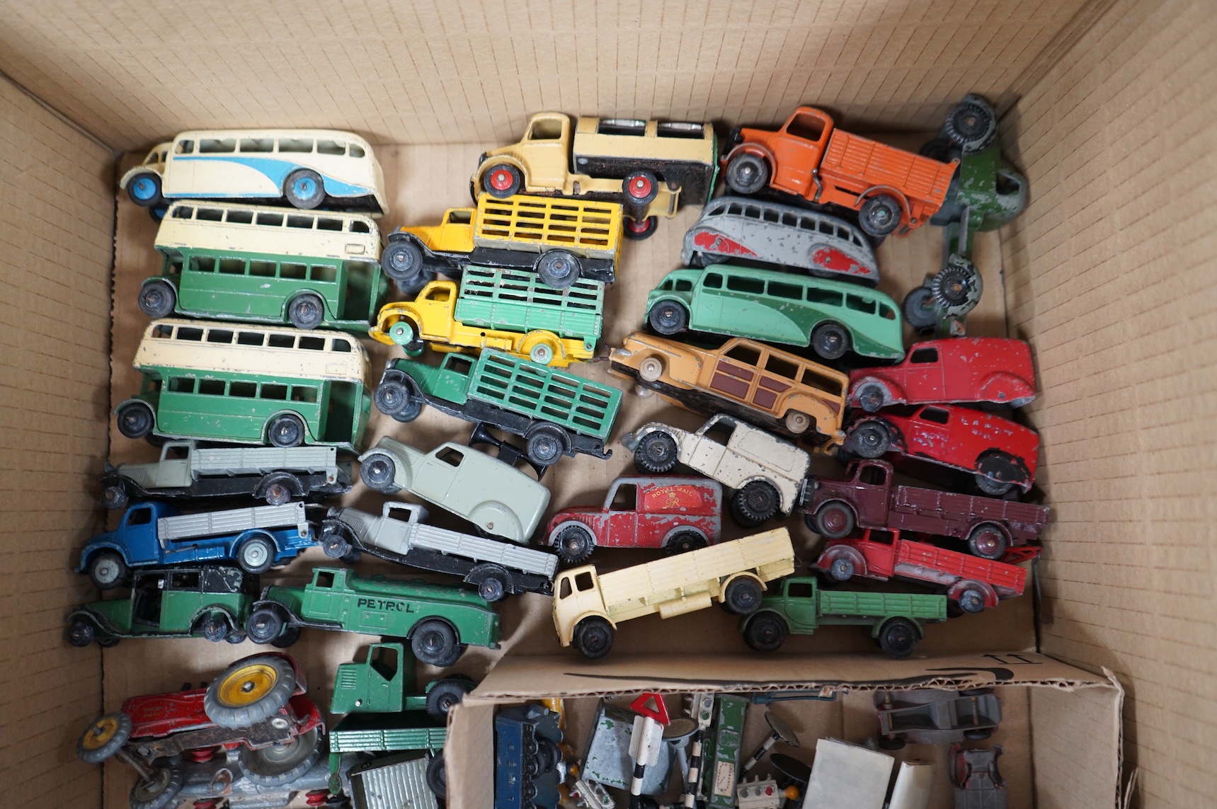 Forty-four 1950s/60s Dinky Toys, etc. including thirty-two commercial vehicles, public transport vehicles, etc. including; market gardener’s wagons, petrol wagons, double deck buses, a Bedford tipper, racing cars, a mech
